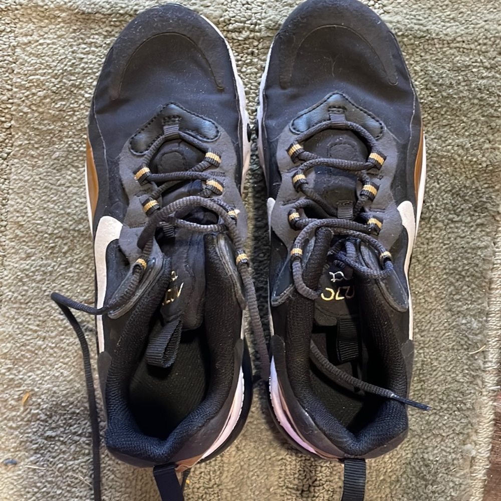 They are women’s shoes and are black gold and are Nikes and are barley worn.